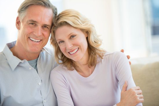 A man and woman smile for the camera.